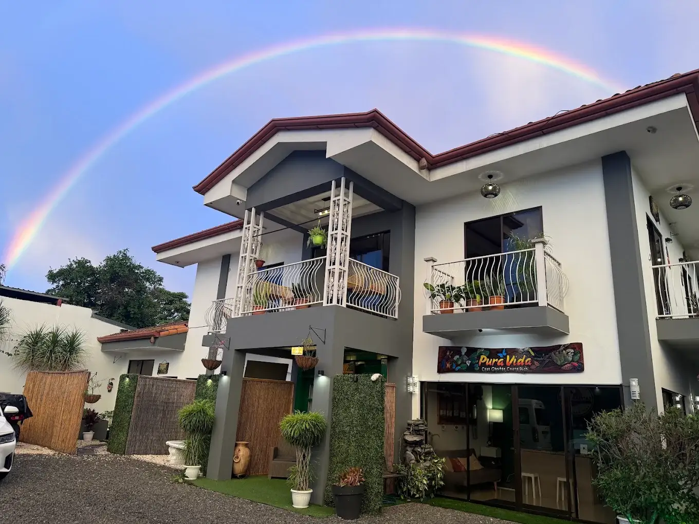 Casa Garitas guesthouse exterior with a rainbow above the building