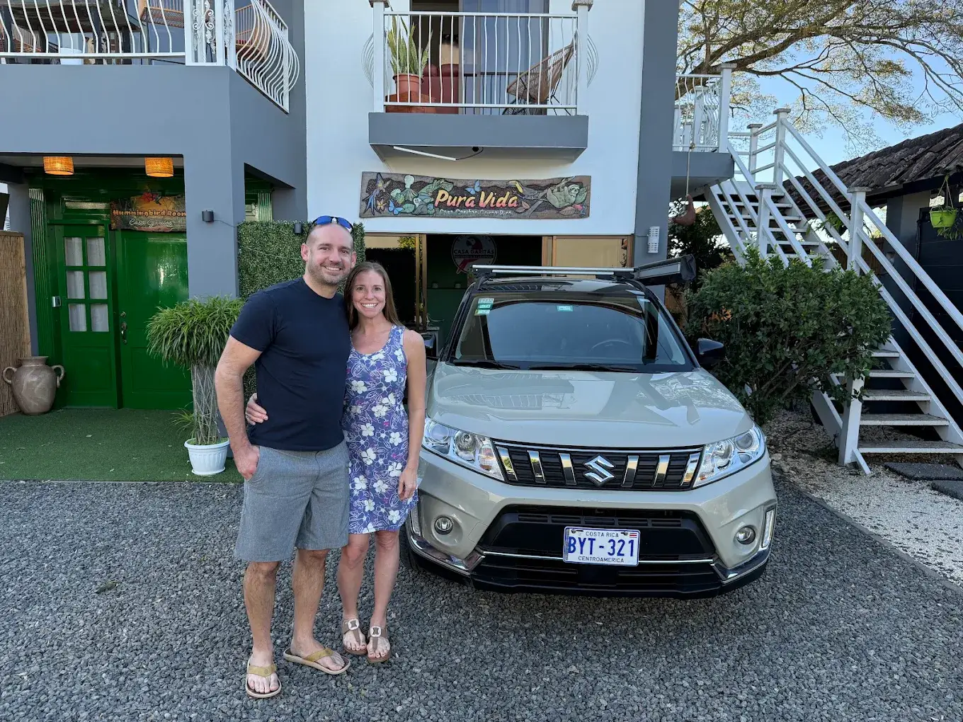 Guests standing beside a Suzuki vehicle in front of Casa Garitas
