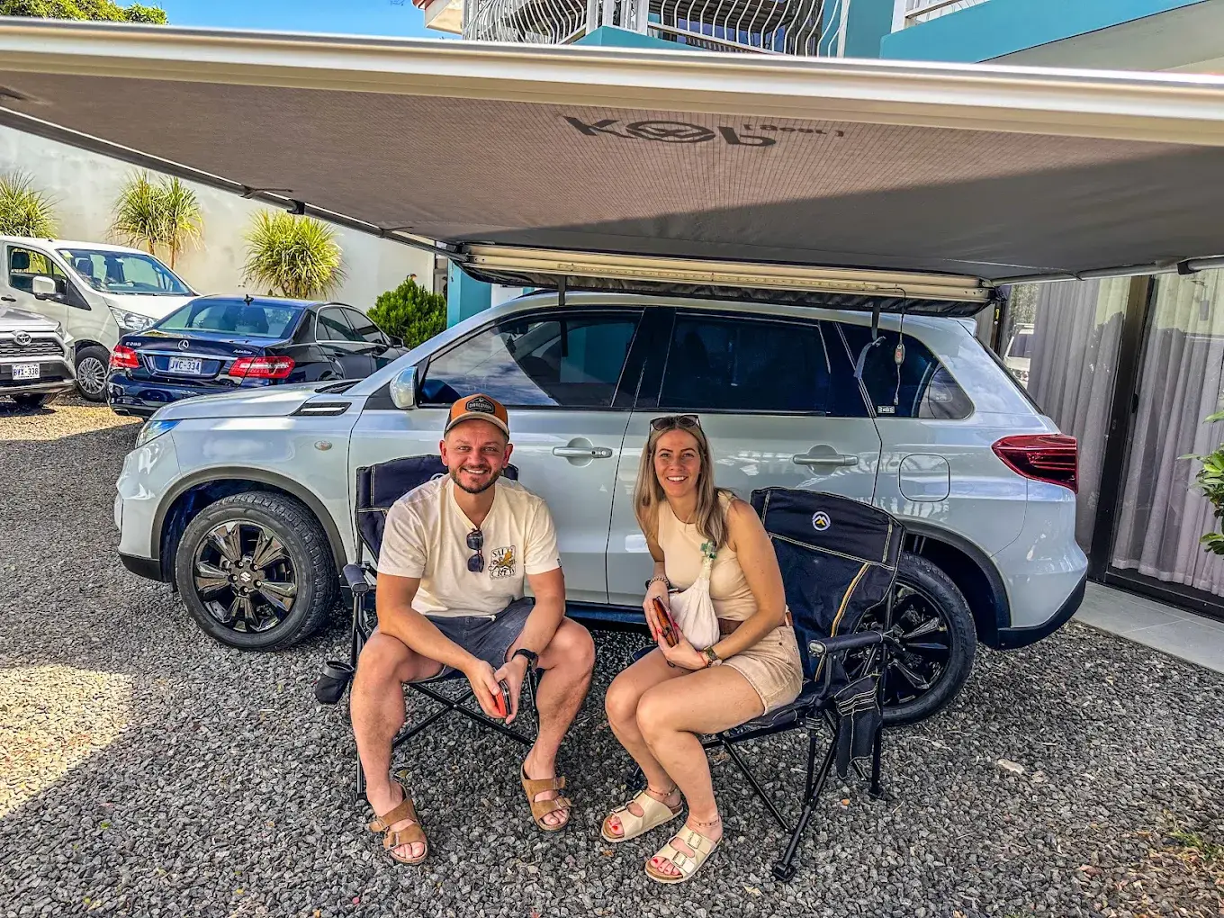 Guests seated in front of a Casa Garitas rental SUV